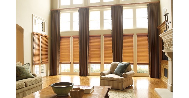 Hartford great room with natural wood blinds and full-length draperies.